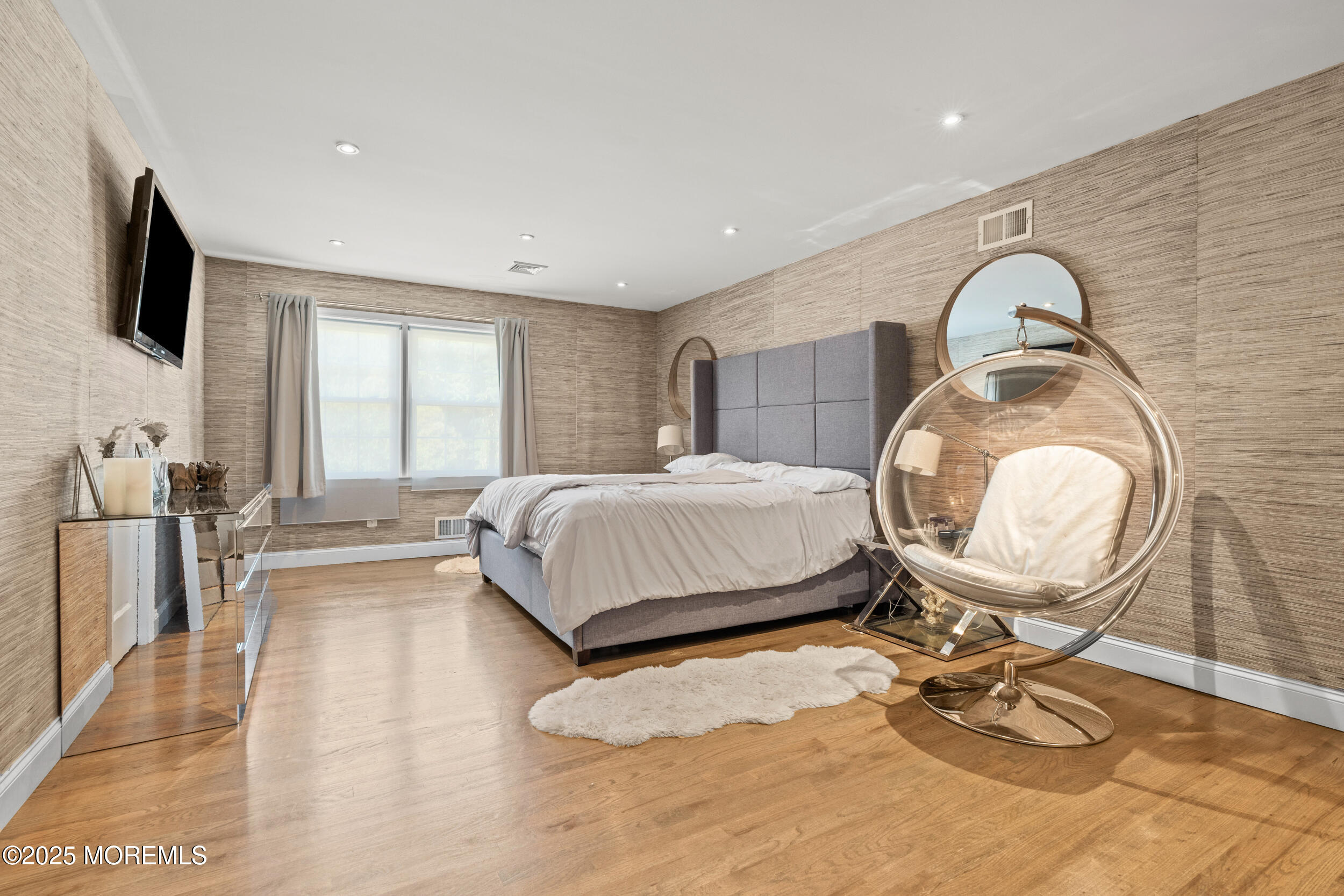 80 Cooper Avenue West Long Branch, NJ 07764 - Photo 16 of 32 a bedroom with a bed a mirror and a flat screen tv