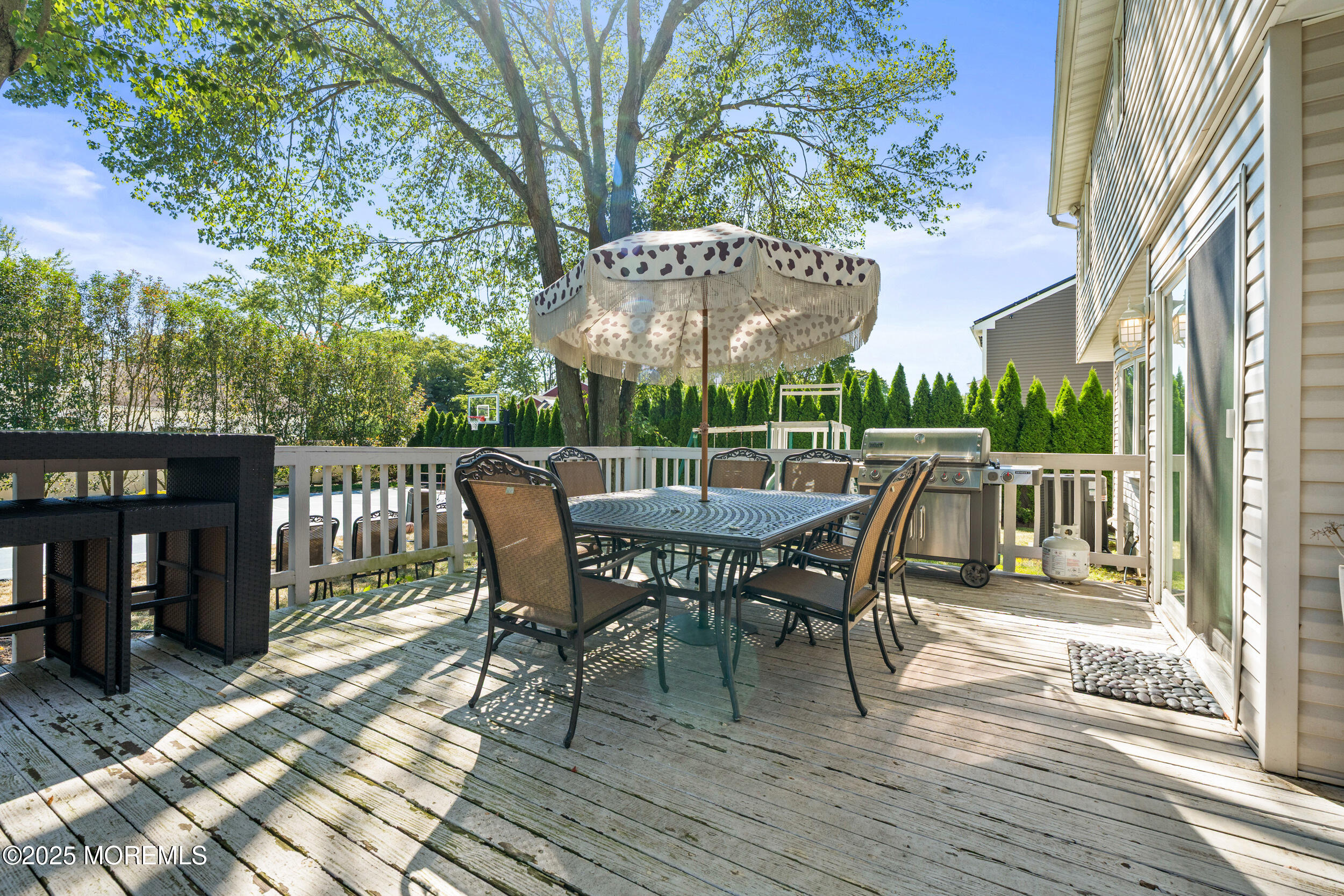 80 Cooper Avenue West Long Branch, NJ 07764 - Photo 31 of 32 a view of a patio with table and chairs with wooden floor and fence