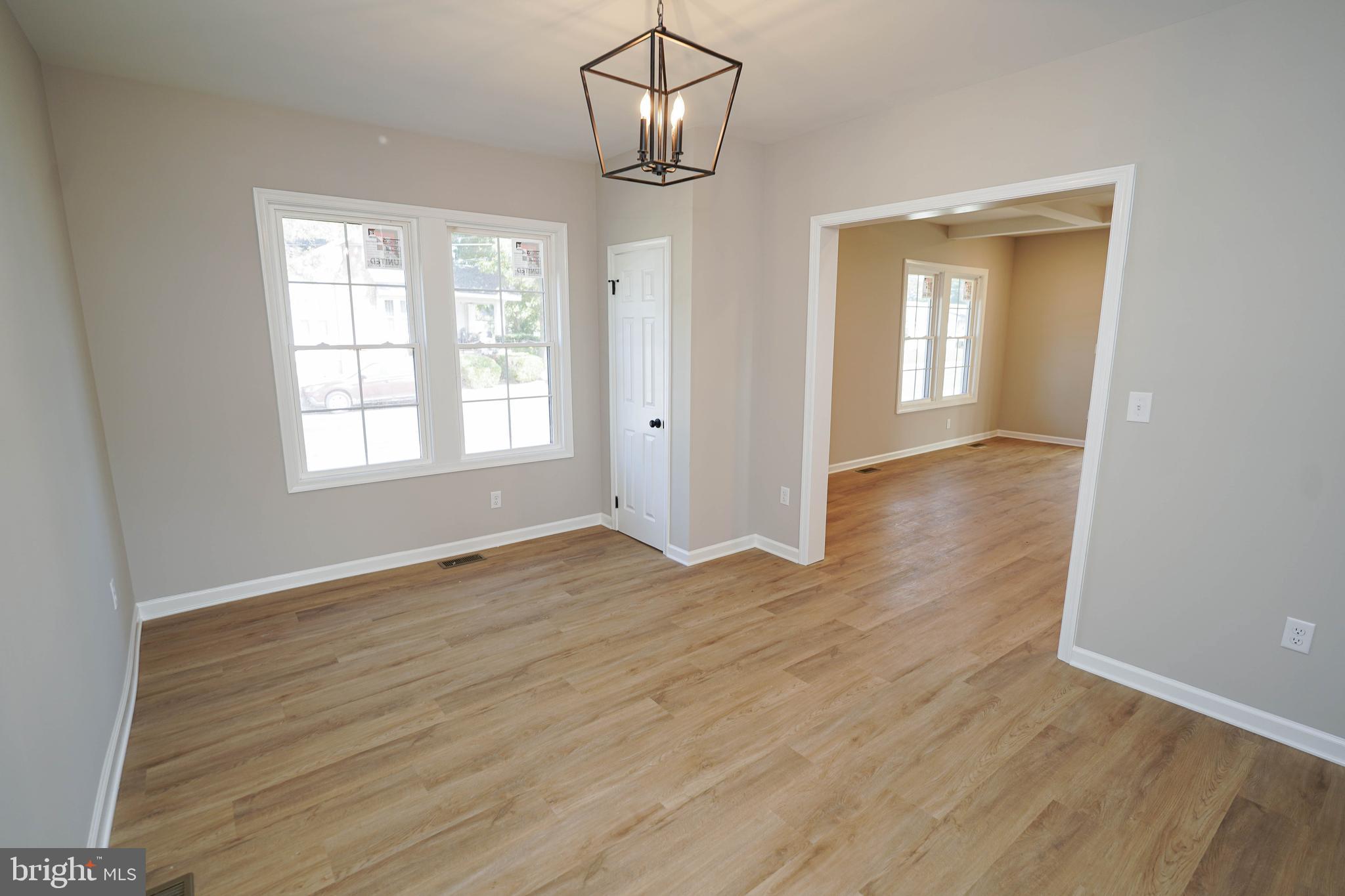 406 Delaware Avenue Delmar, DE 19940 - Photo 13 of 48 a view of an empty room with wooden floor and a window
