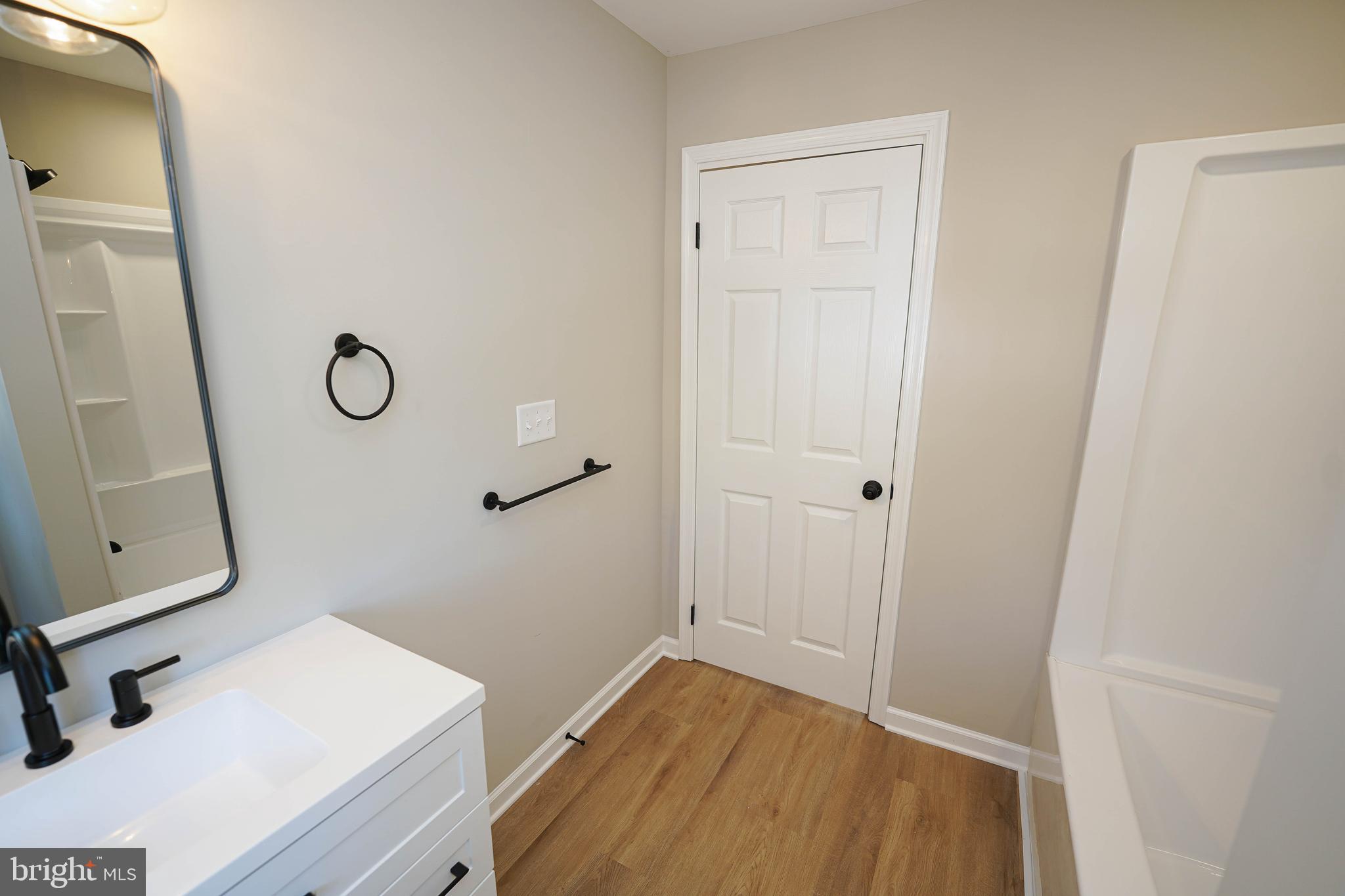 406 Delaware Avenue Delmar, DE 19940 - Photo 27 of 48 a bathroom with a sink and a mirror