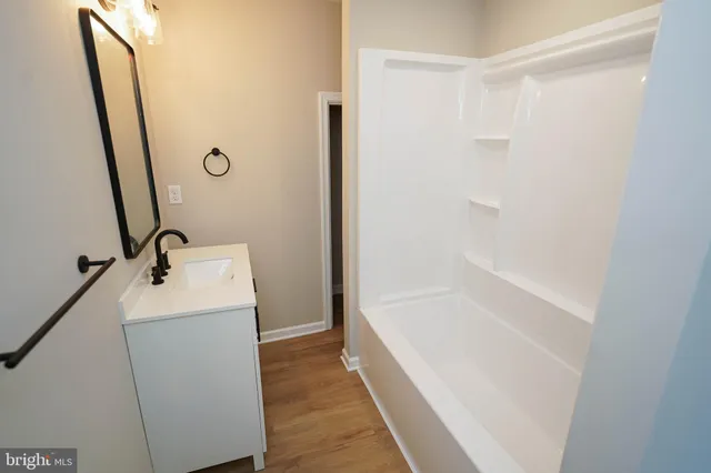 a bathroom with a sink a mirror and a bathtub