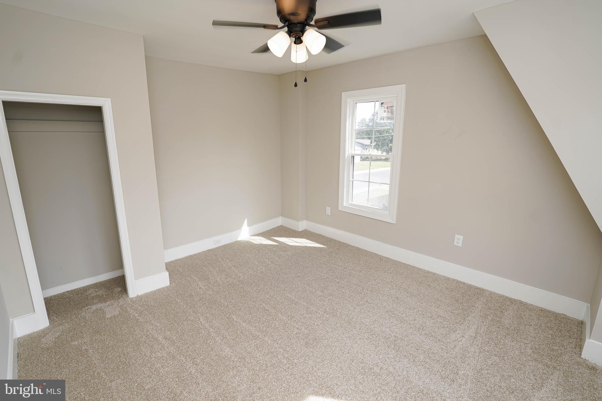 406 Delaware Avenue Delmar, DE 19940 - Photo 36 of 48 an empty room with a window and a fan