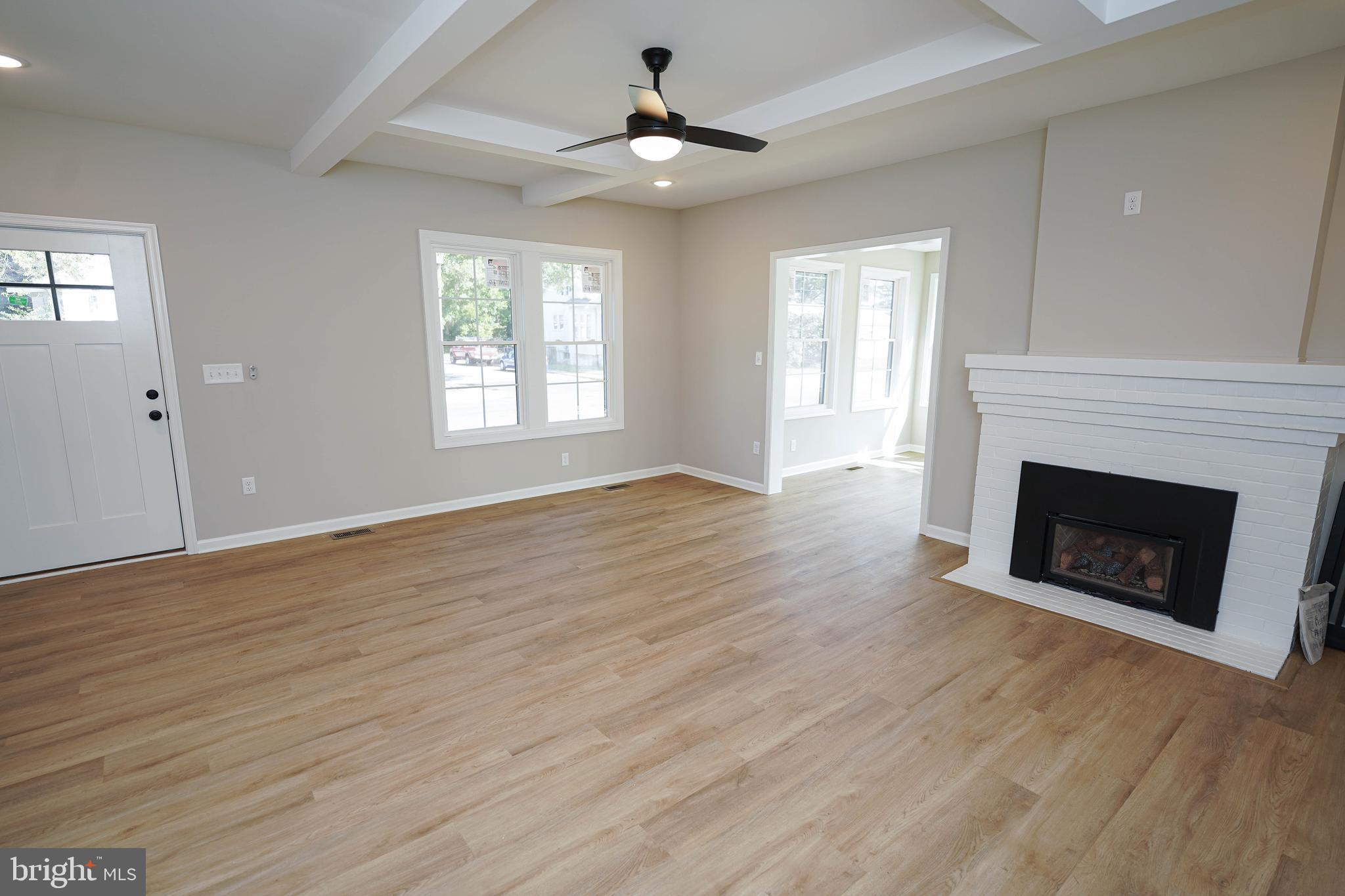 406 Delaware Avenue Delmar, DE 19940 - Photo 5 of 48 a view of a livingroom with a fireplace wooden floor and windows