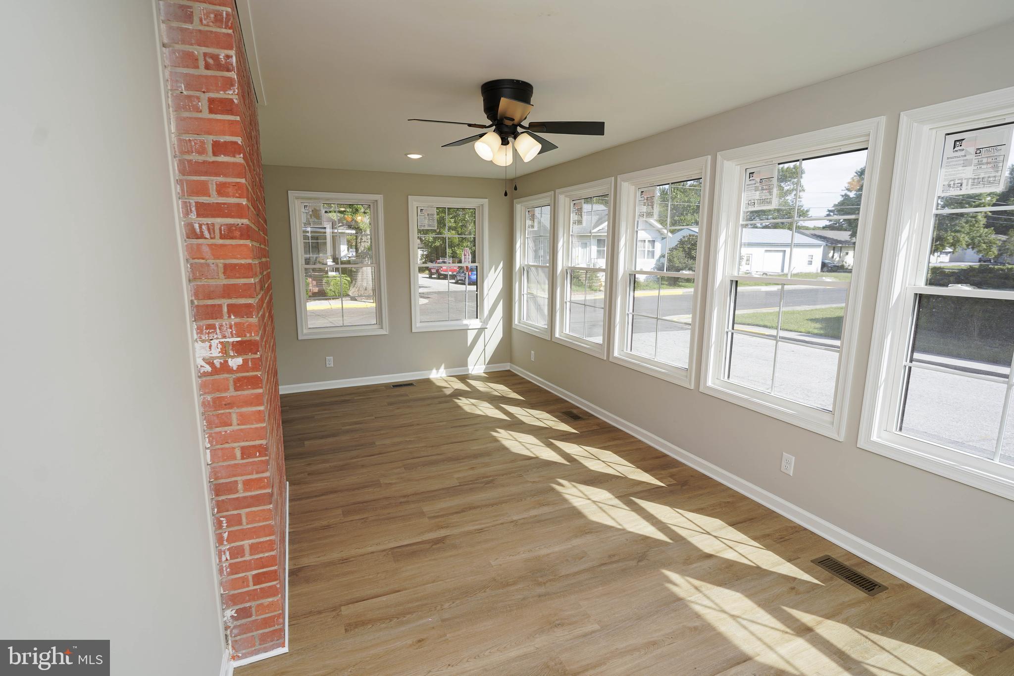 406 Delaware Avenue Delmar, DE 19940 - Photo 10 of 48 a view of an empty room with a window and wooden floor