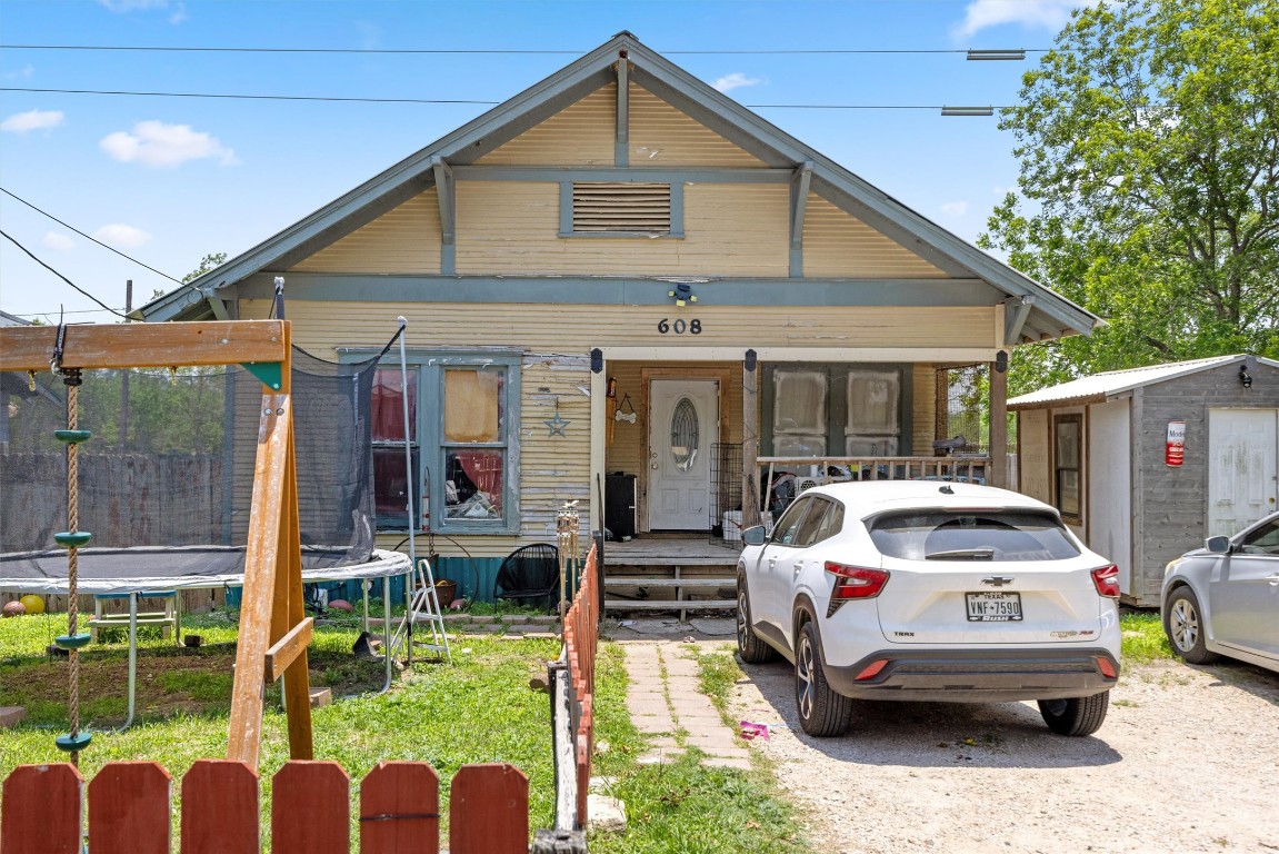 608 East Pecan Street Taylor, TX 76574 - Photo 1 of 1 a white house covered with tall trees
