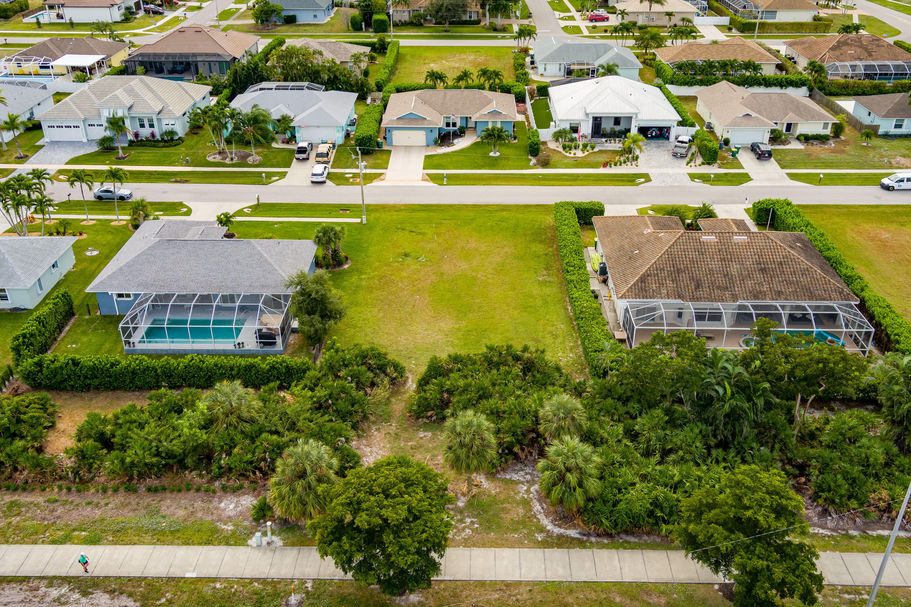 1414 Delbrook Way Marco Island, FL 34145 - Photo 5 of 21 an aerial view of a swimming pool with lawn chairs and large trees