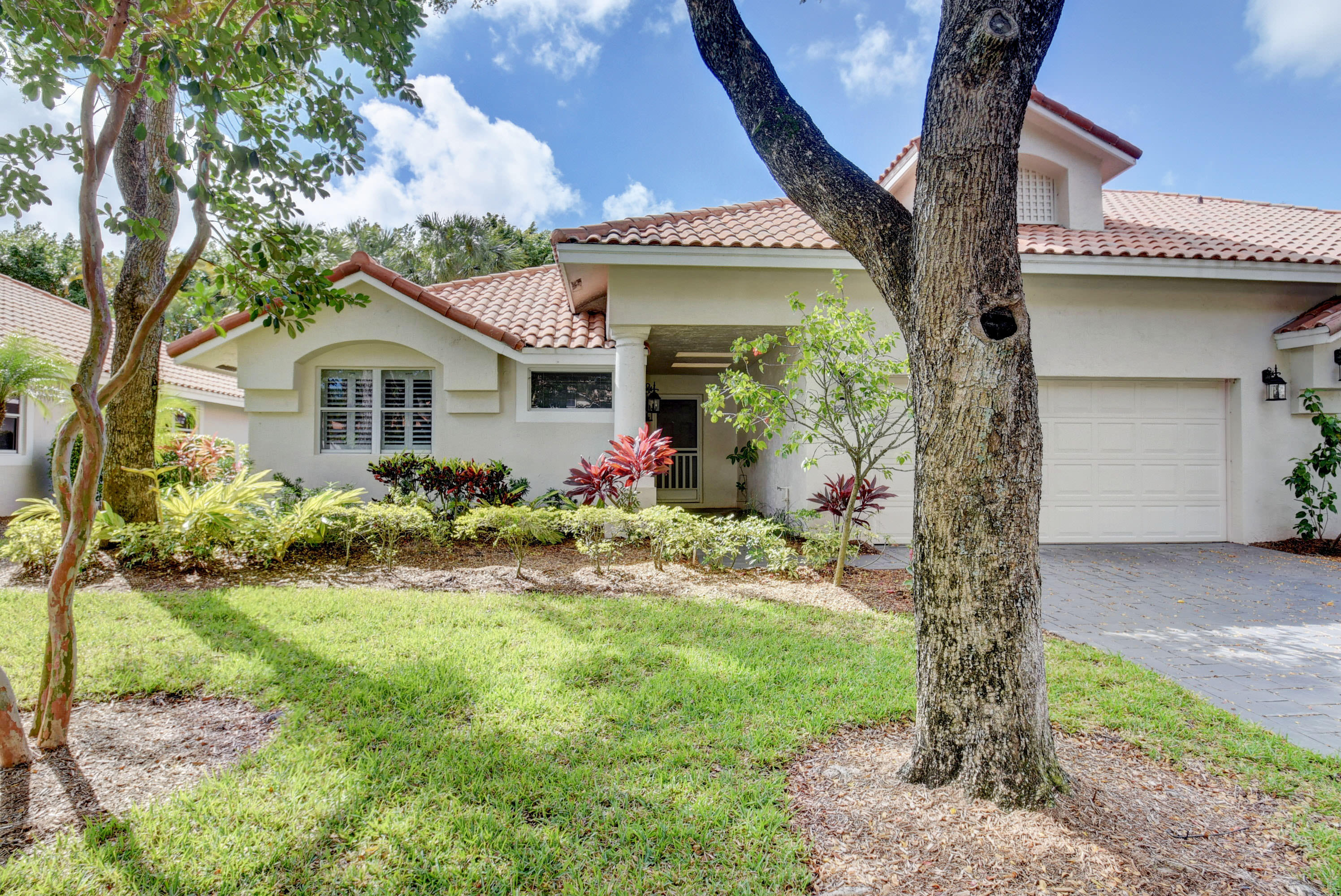 2254 Northwest 52nd Street Boca Raton, FL 33496 - Photo 1 of 28 a front view of a house with garden
