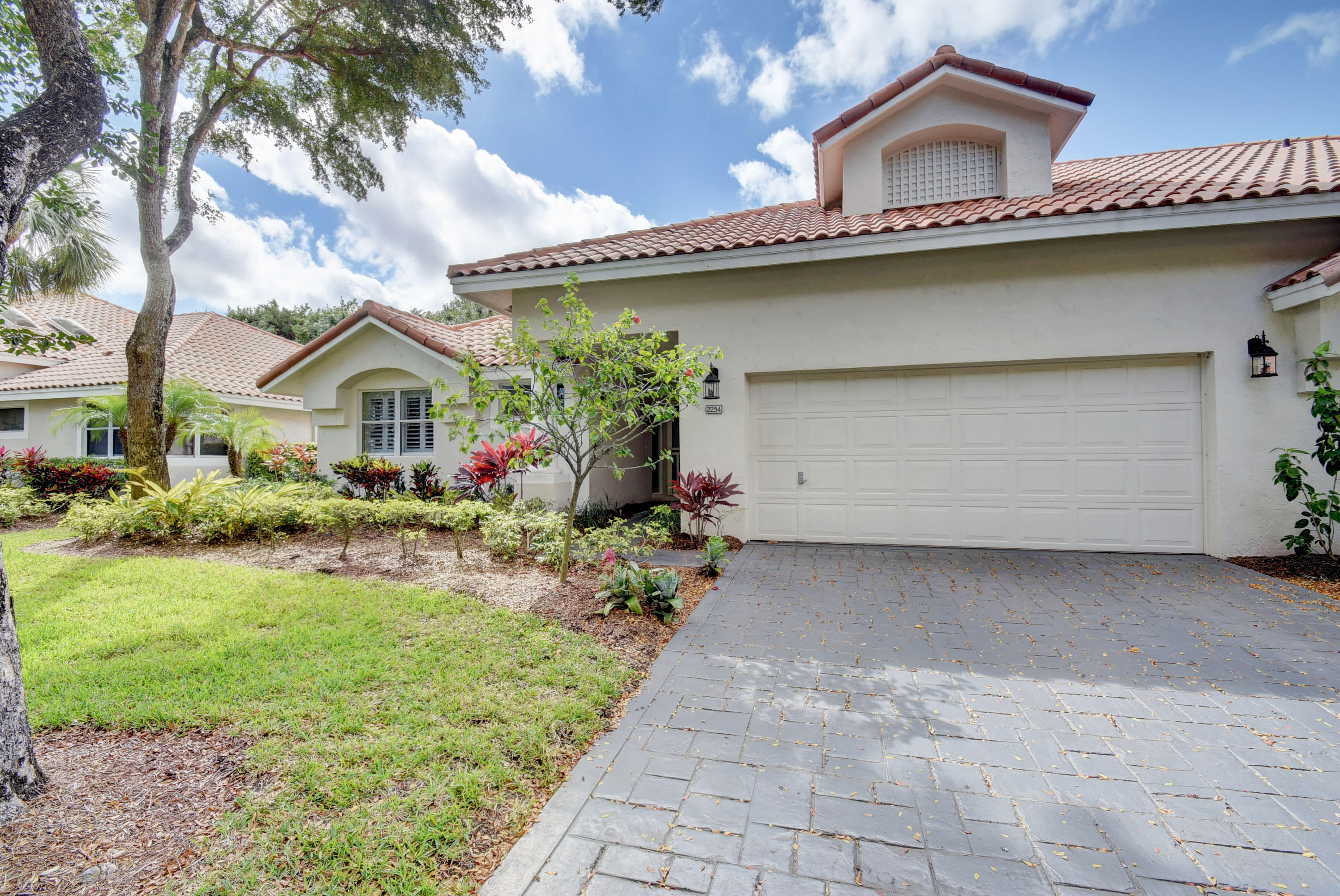 2254 Northwest 52nd Street Boca Raton, FL 33496 - Photo 2 of 28 a view of a house with a garden