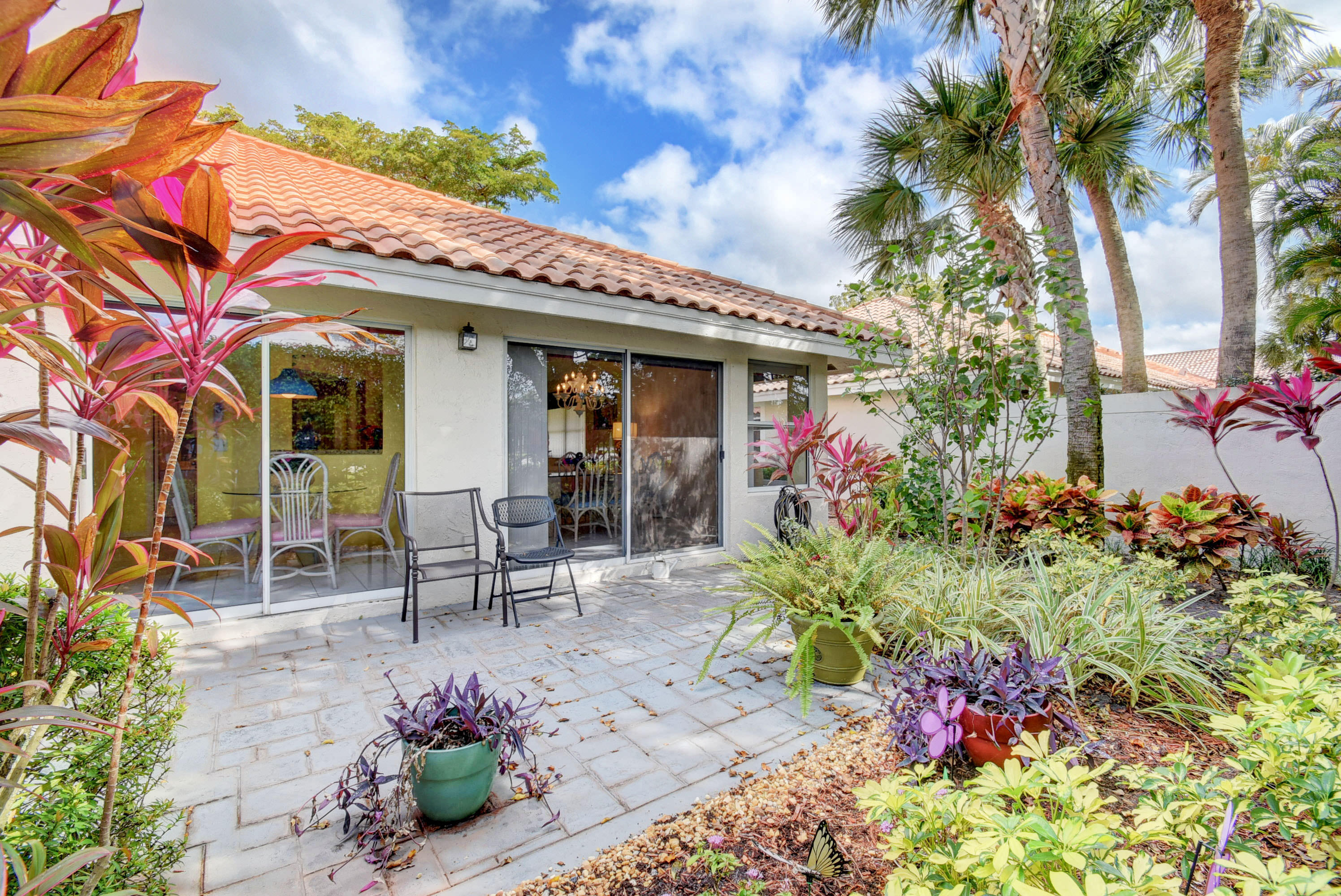 2254 Northwest 52nd Street Boca Raton, FL 33496 - Photo 22 of 28 a view of a patio with table and chairs and potted plants