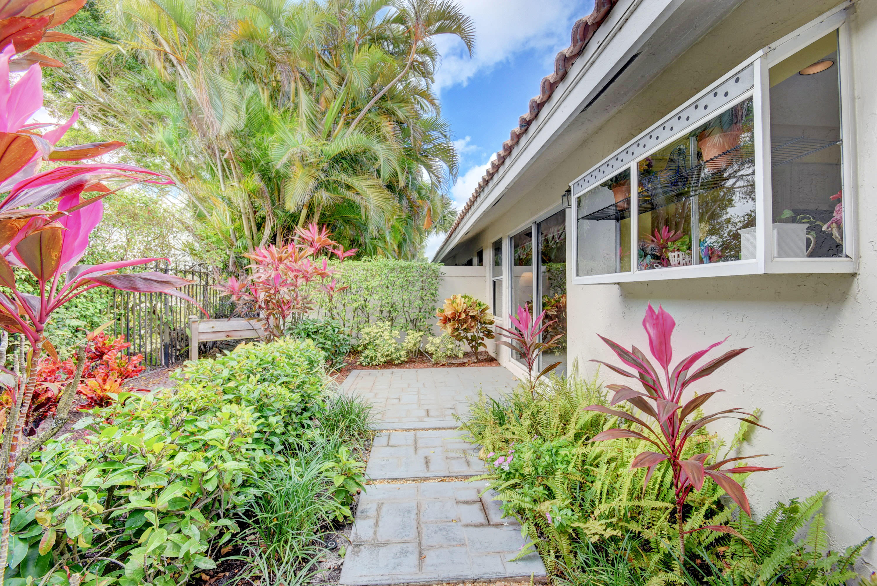 2254 Northwest 52nd Street Boca Raton, FL 33496 - Photo 24 of 28 a potted plant sitting in front of a house