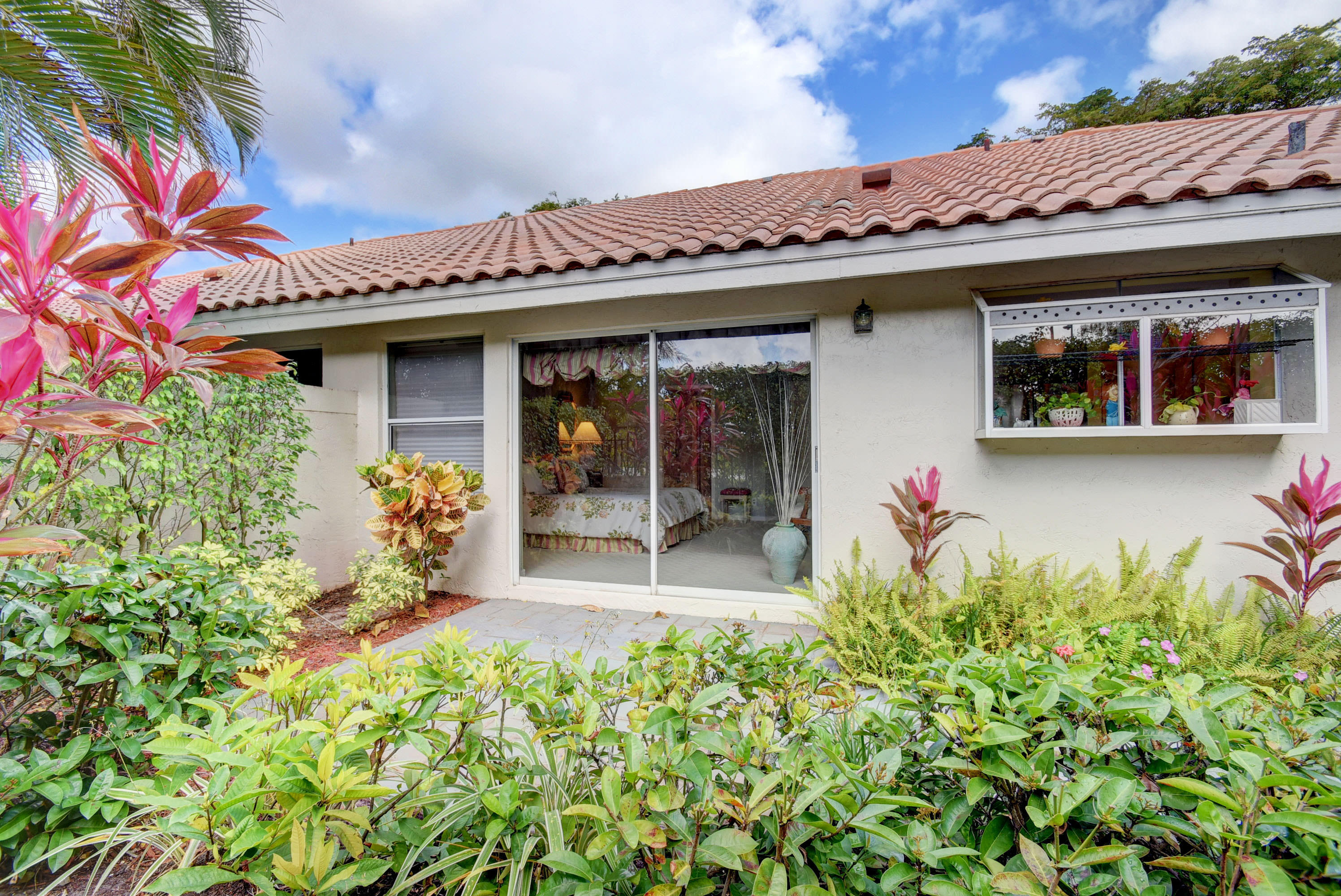 2254 Northwest 52nd Street Boca Raton, FL 33496 - Photo 26 of 28 a front view of a house with a porch
