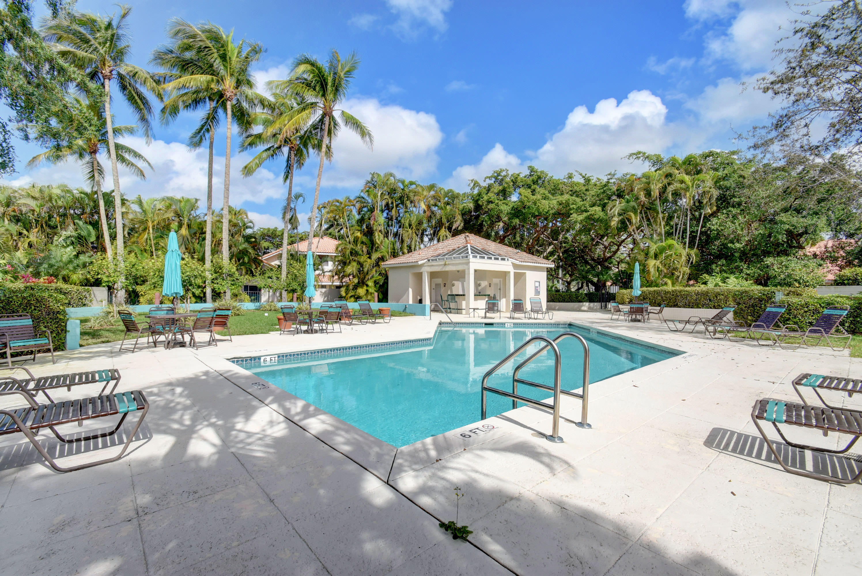 2254 Northwest 52nd Street Boca Raton, FL 33496 - Photo 27 of 28 a view of a swimming pool with a lounge chairs