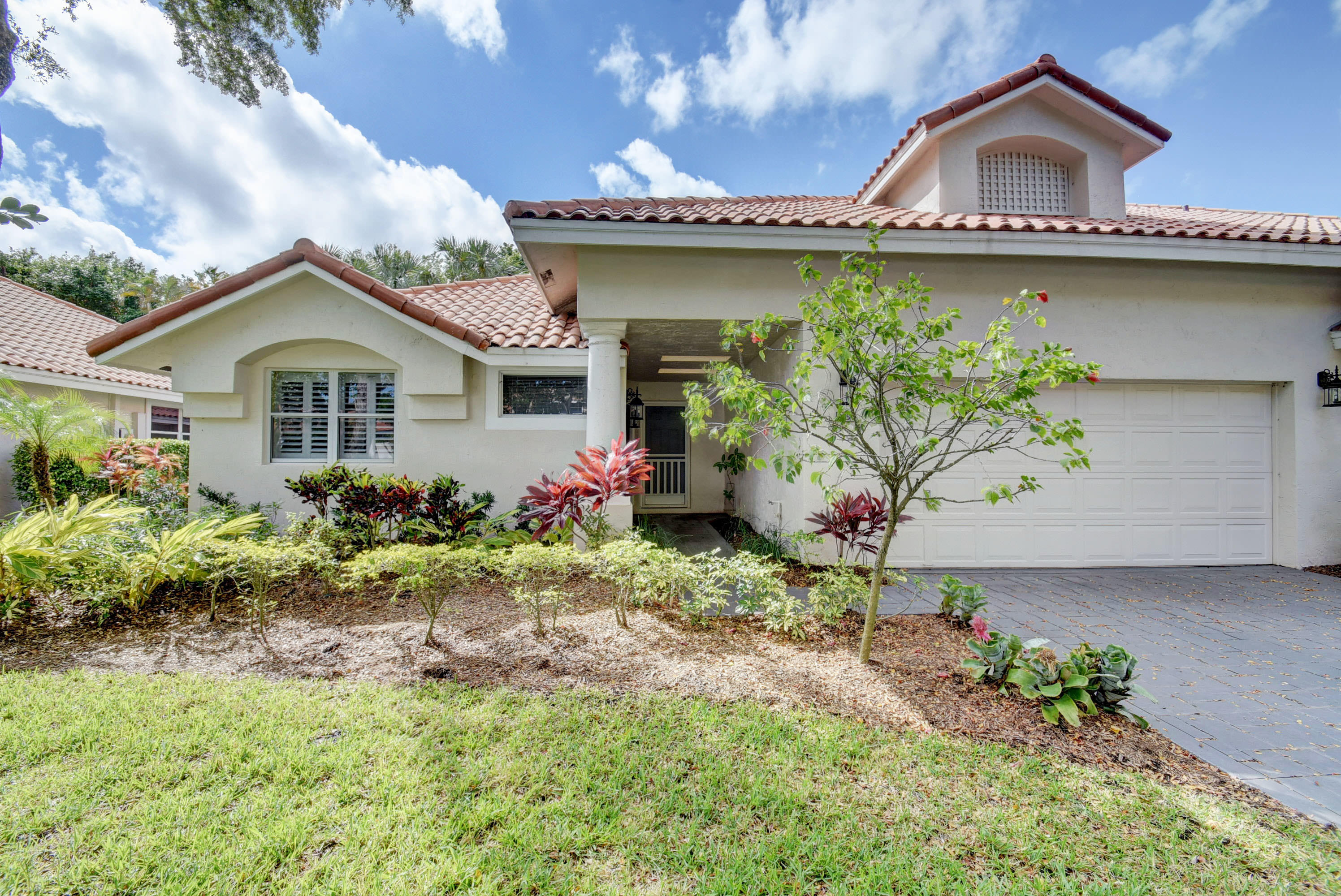2254 Northwest 52nd Street Boca Raton, FL 33496 - Photo 3 of 28 a front view of a house with a garden