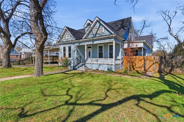 a view of a house with a yard patio and fire pit