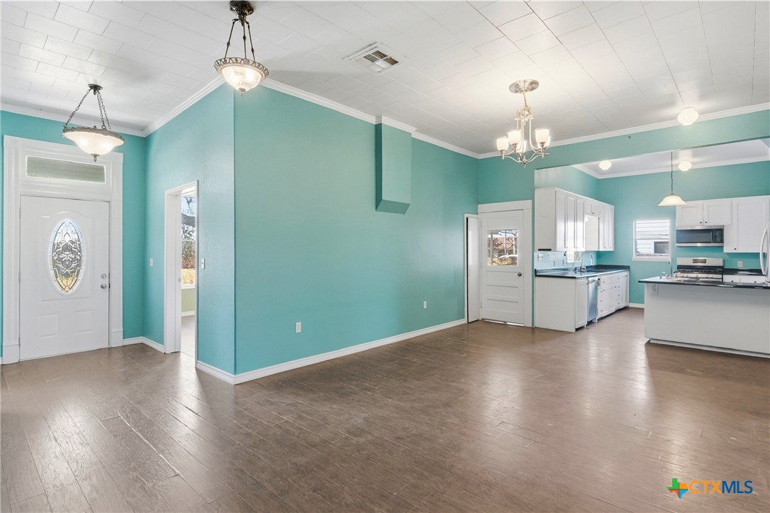 222 East Cedar Street Seguin, TX 78155 - Photo 11 of 46 a view of a kitchen with a refrigerator and a stove top oven