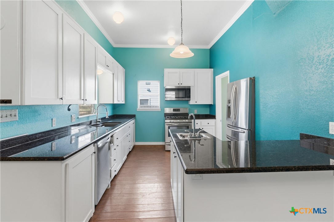 222 East Cedar Street Seguin, TX 78155 - Photo 13 of 46 a large kitchen with a refrigerator a stove top oven a sink and dishwasher