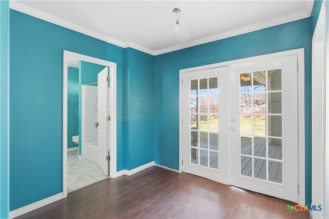 222 East Cedar Street Seguin, TX 78155 - Photo 18 of 46 a view of empty room with wooden floor and fan