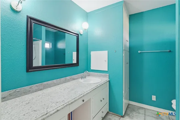 a bathroom with a sink and a mirror