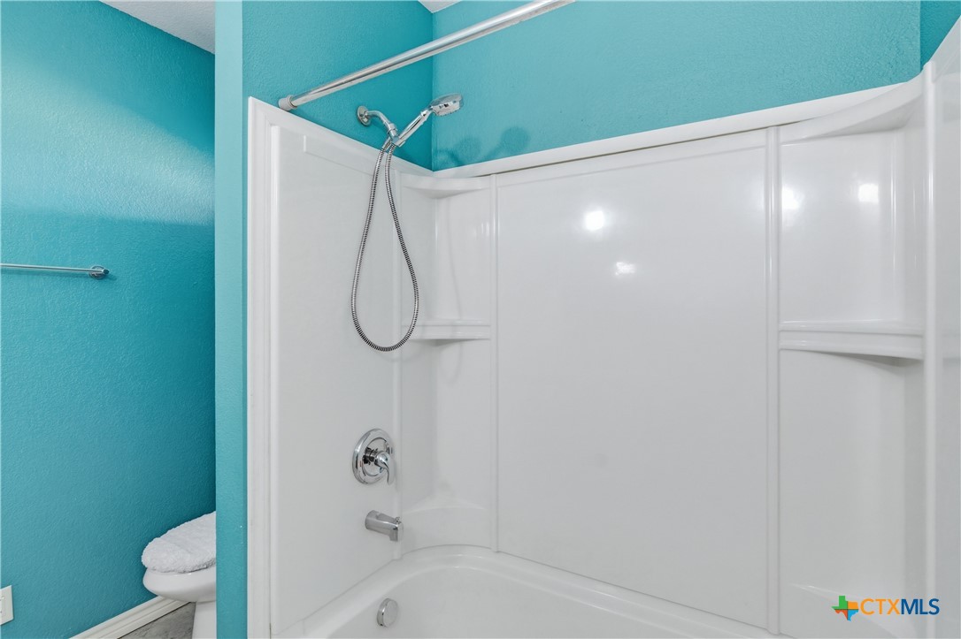 222 East Cedar Street Seguin, TX 78155 - Photo 20 of 46 a bathroom with a shower and a toilet