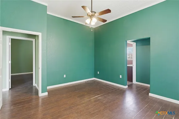 a view of empty room with wooden floor