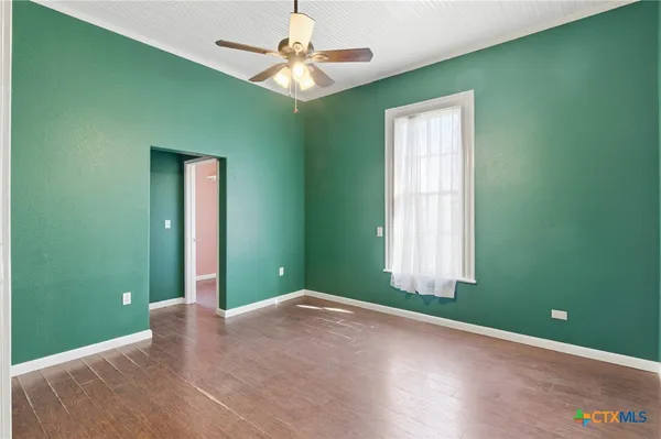 a view of a room with a large window and fan