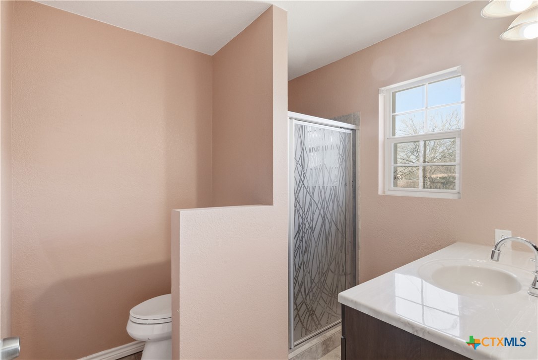 222 East Cedar Street Seguin, TX 78155 - Photo 24 of 46 a bathroom with a sink toilet and vanity