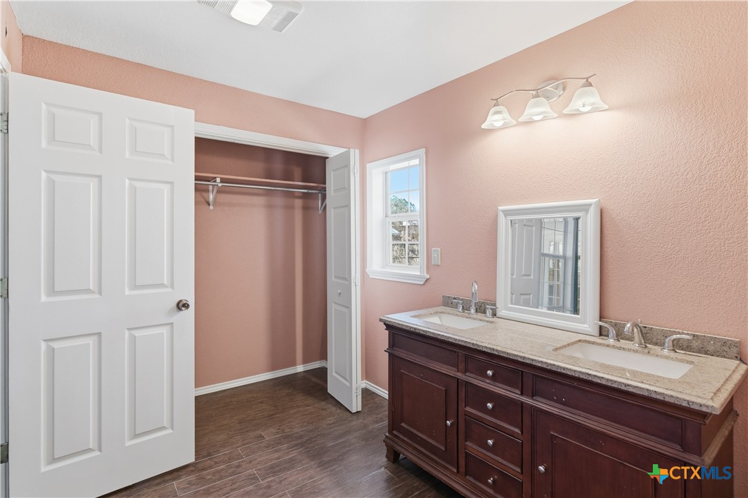 222 East Cedar Street Seguin, TX 78155 - Photo 26 of 46 a bathroom with a double vanity sink and a mirror