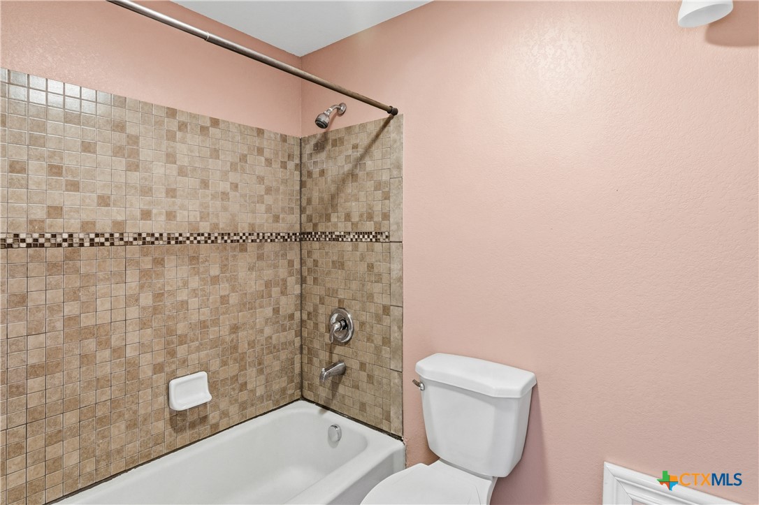 222 East Cedar Street Seguin, TX 78155 - Photo 27 of 46 a bathroom with a toilet and a shower