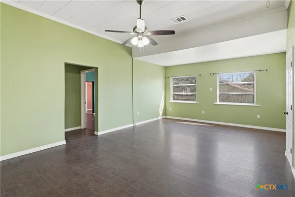 a view of livingroom with window wooden floor and windows