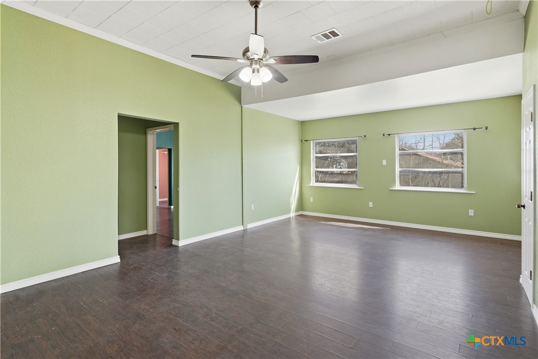 222 East Cedar Street Seguin, TX 78155 - Photo 34 of 46 a view of an empty room with a window and wooden floor