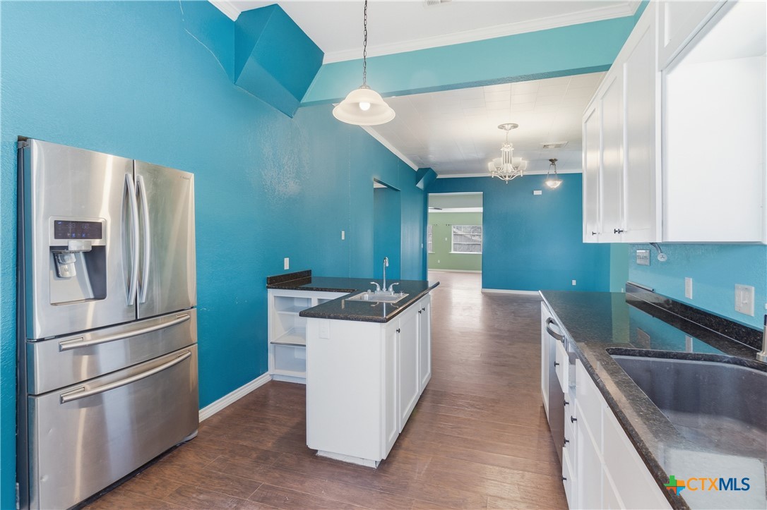 222 East Cedar Street Seguin, TX 78155 - Photo 9 of 46 a kitchen with stainless steel appliances granite countertop a refrigerator a sink and a stove