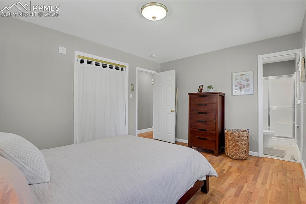 1417 Prairie Road Colorado Springs, CO 80909 - Photo 13 of 34 a bedroom with a bed and dresser