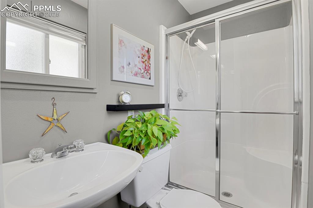 1417 Prairie Road Colorado Springs, CO 80909 - Photo 14 of 34 a bathroom with a sink and a mirror