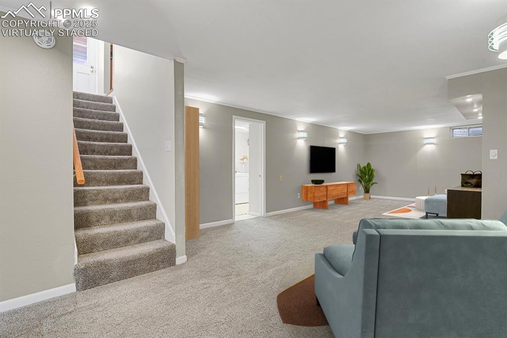 1417 Prairie Road Colorado Springs, CO 80909 - Photo 18 of 34 a view of a livingroom with furniture and stairs