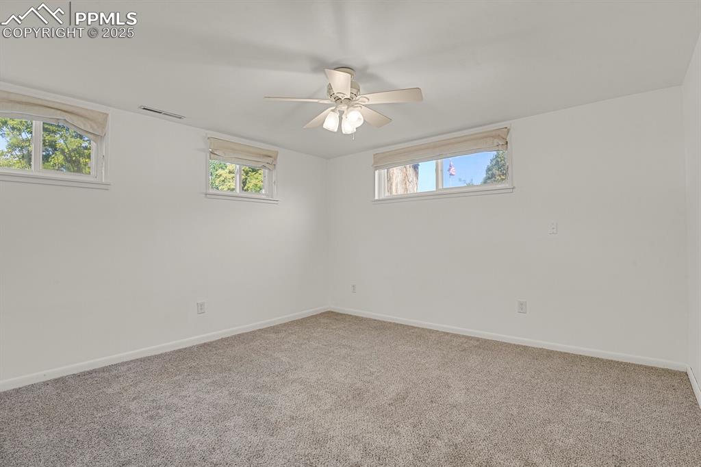 1417 Prairie Road Colorado Springs, CO 80909 - Photo 23 of 34 an empty room with a window and a fan