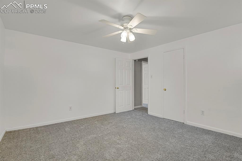 1417 Prairie Road Colorado Springs, CO 80909 - Photo 24 of 34 a view of an empty room with a chandelier fan