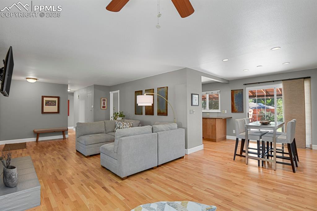 1417 Prairie Road Colorado Springs, CO 80909 - Photo 5 of 34 a living room with furniture and a wooden floor