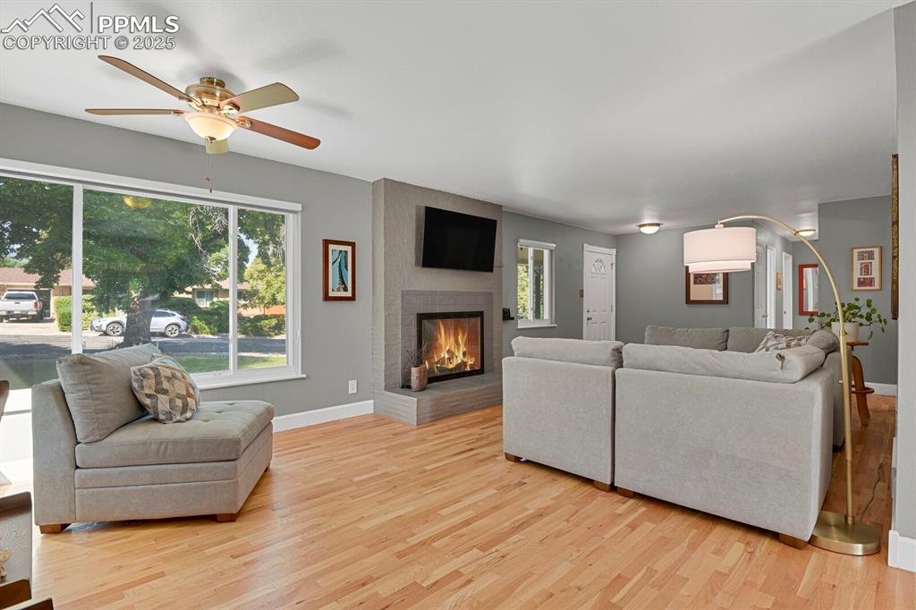 1417 Prairie Road Colorado Springs, CO 80909 - Photo 6 of 34 a living room with furniture fireplace and a large window