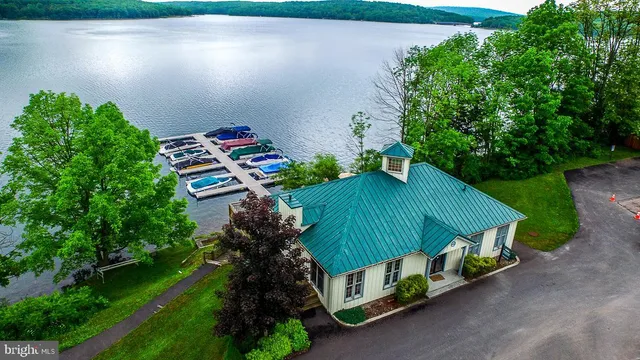 an aerial view of a house with backyard and garden
