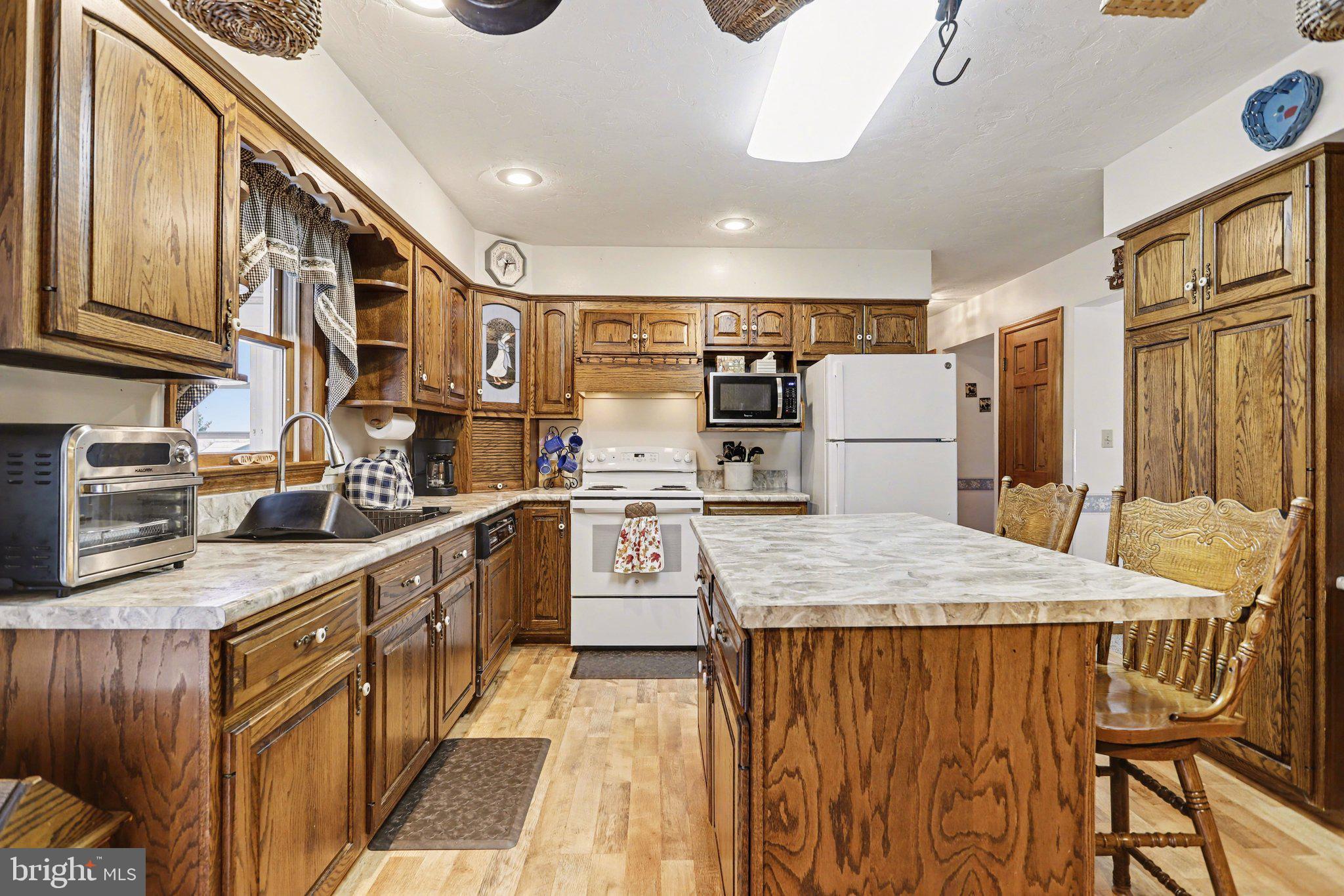 11 Narrow Road Hanover, PA 17331 - Photo 11 of 36 a kitchen with a table chairs refrigerator and cabinets