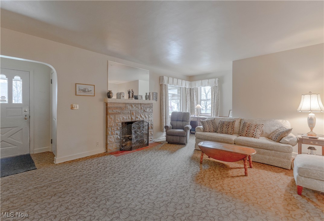 3631 Dover Road Youngstown, OH 44511 - Photo 4 of 20 Carpeted living area with a stone fireplace and arched walkways