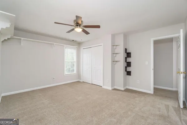 a view of room with a ceiling fan and window