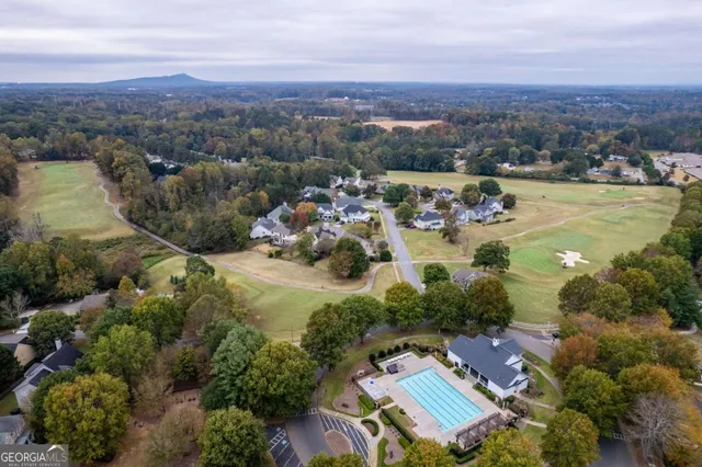 an aerial view of a house with a yard