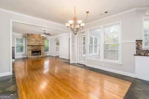 a view of an empty room with a fireplace and a window