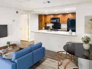 a living room with furniture and flat screen tv