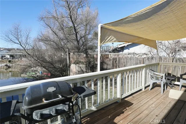 a view of a house with a wooden door and a bench