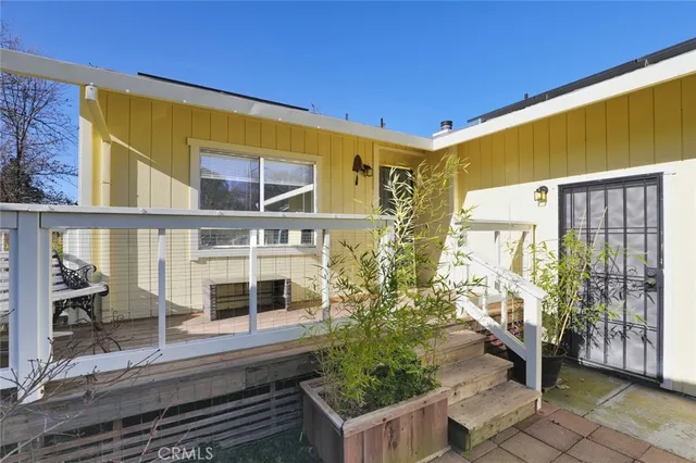 a view of balcony with wooden floor and seating space