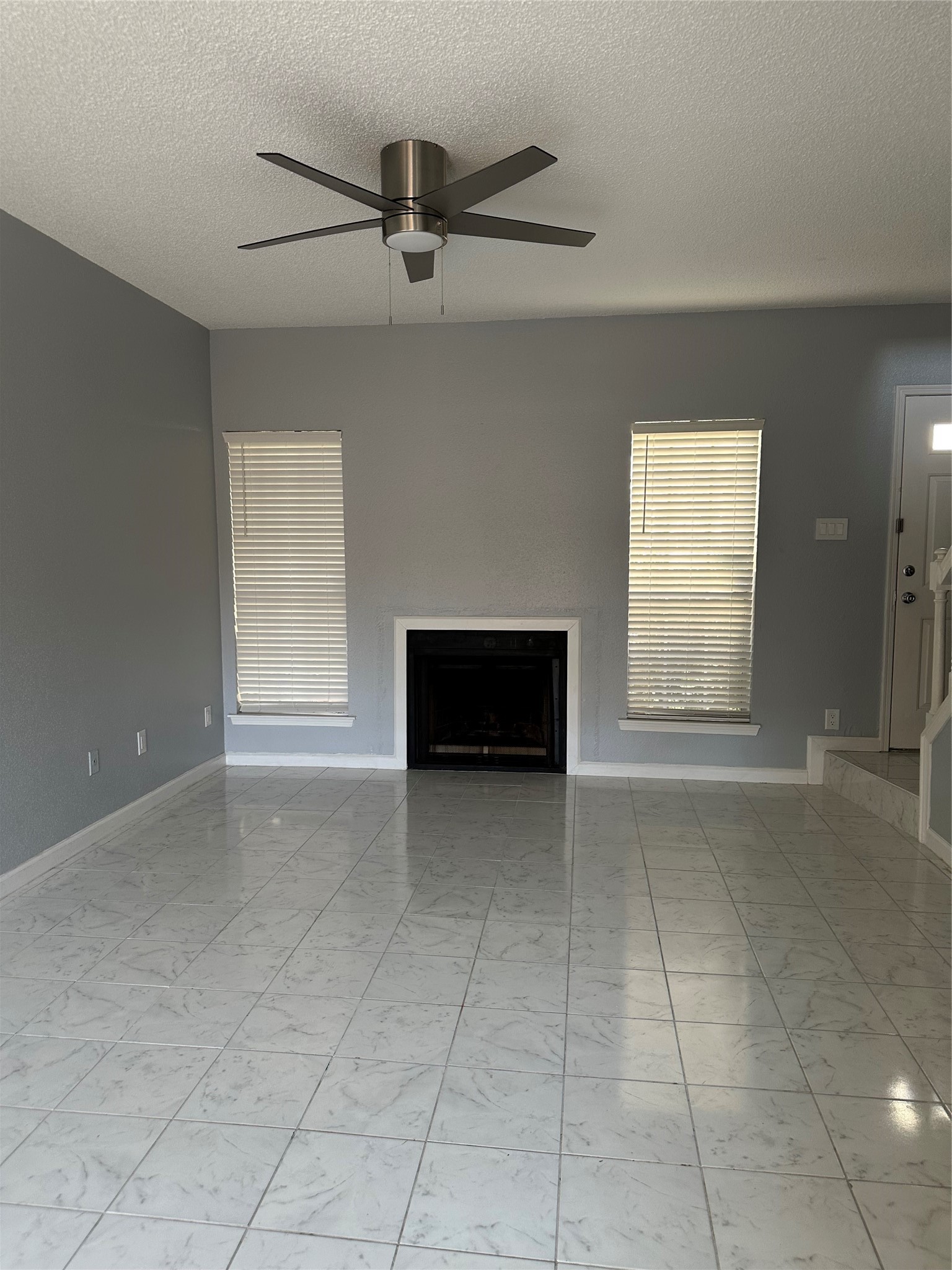 7575 Cambridge Street, Unit 2303 Houston, TX 77054 - Photo 4 of 7 a view of an empty room with a window and fireplace