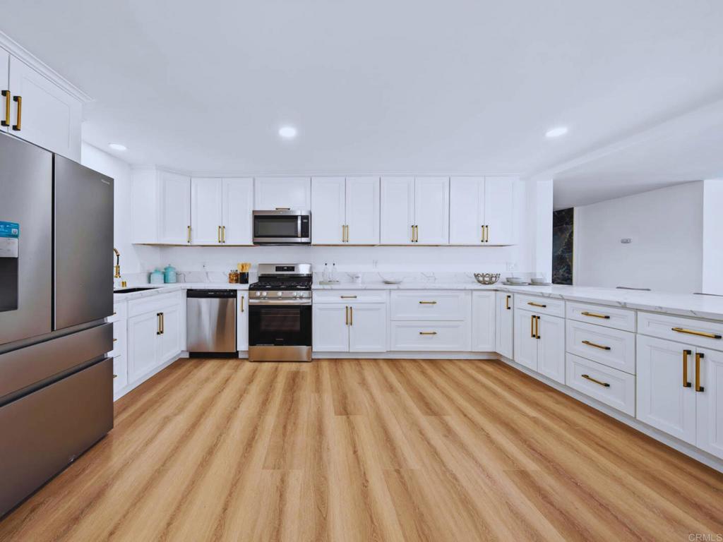 1894 Wedgemere Road El Cajon, CA 92020 - Photo 12 of 60 a kitchen with granite countertop white cabinets and stainless steel appliances
