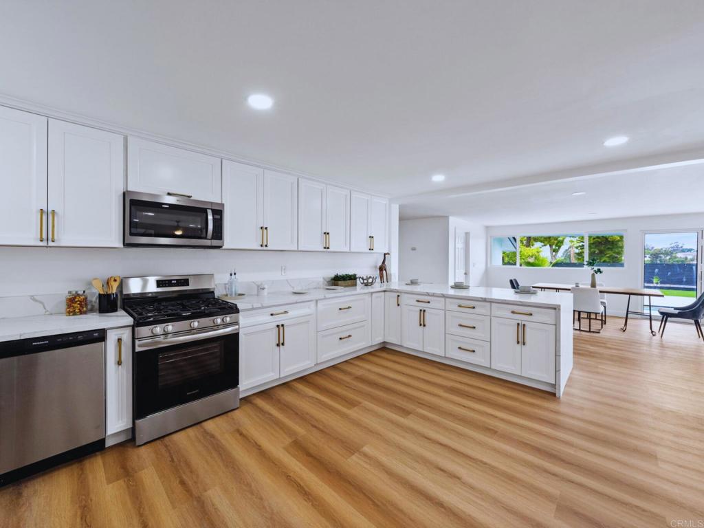 1894 Wedgemere Road El Cajon, CA 92020 - Photo 13 of 60 a kitchen with stainless steel appliances granite countertop a stove top oven a sink dishwasher and a microwave oven with wooden floor